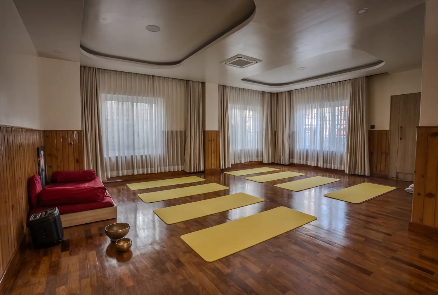 Meditation hall with bolster, speaker and singing bowls